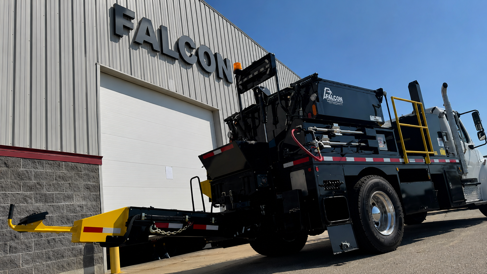 Falcon asphalt patch truck equipped with an extended Material Delivery System auger chute